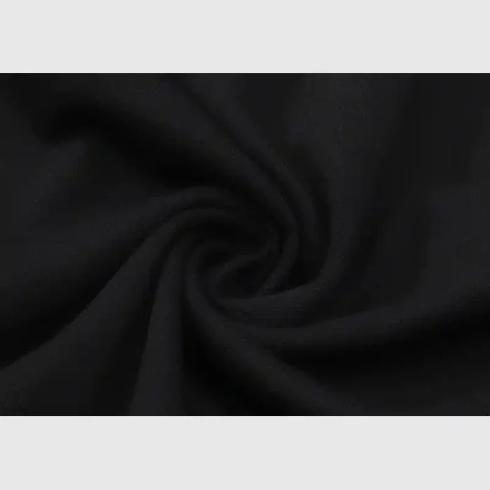 Close-up of a dark fabric with a swirl pattern, reminiscent of the Hellstar Path To Paradise T-Shirt, highlighting its texture and soft folds. The fabric seems smooth and slightly matte, enhancing the depth of its dark color.