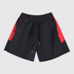 The "b" product features black athletic shorts with vibrant red side panels, an elastic waistband, and a drawstring. Designed for both sports and leisure activities, these shorts provide comfort as well as style.